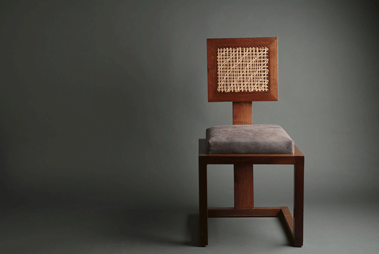 Figments This chair is inspired by the namesake architect, Ludwig Mies Van Der Rohe. Blocked walnut wood sections, a strategically tapered back and cane woven rest are put to use in order to create this piece.